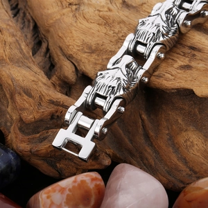 Men's biker chain bracelet with wolf head carving on vintage wood background