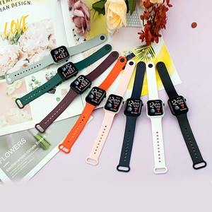 Vibrant fan-shaped display of digital watches in eight colors on a stylish desk