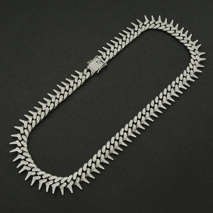 Close-up of spiked Cuban link chain featuring icy square clasp and full pavé rhinestones