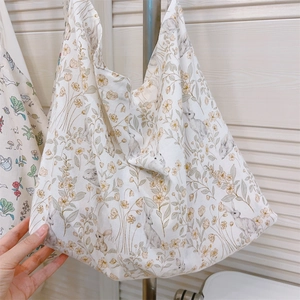 Detail of floral and rabbit print on a white cotton canvas tote bag with a soft texture