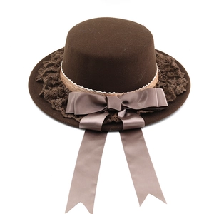 Dark brown wool cloche hat with lace trim and large satin bow decoration on white background