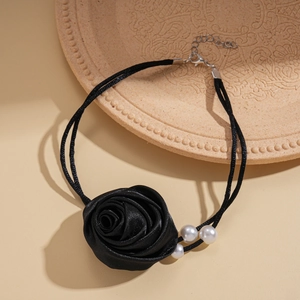 Detail view of handmade black satin rose choker with white faux pearls and twin cords