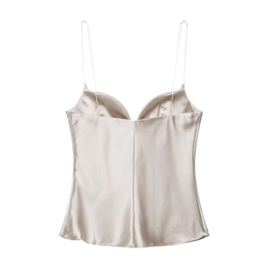 Close-up of champagne satin camisole featuring delicate straps and silky texture