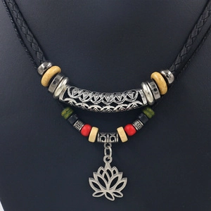 Detailed view of handmade woven rope necklace with cat eye stone and silver lotus pendant