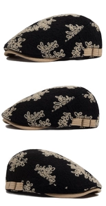 Detail of floral embroidery on black cotton beret with adjustable side metal buckle