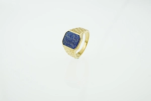 Close-up of square blue lapis lazuli stone set in a textured gold men's signet ring
