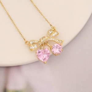 Elegant 18k gold plated necklace with pink heart gems and a butterfly pendant design