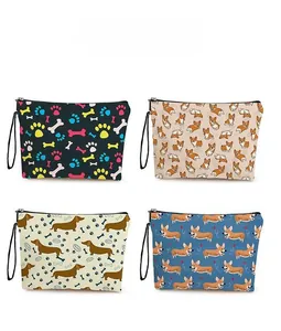Four dog-themed toiletry bags with colorful paw and bone prints featuring black zippers