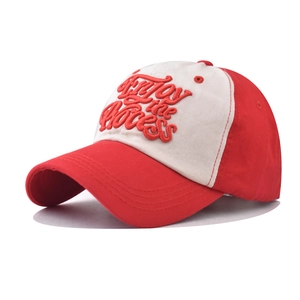 Detail of red and white cotton baseball cap with Enjoy the Process embroidery