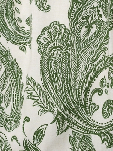 Close-up of green paisley print on off-white cotton blend fabric with detailed texture