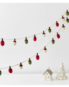 Detail of wool felt acorn garland with red, cream and green balls for Christmas decor