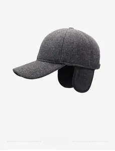 Detail view of winter baseball cap with warm ear flaps and textured dark grey wool fabric