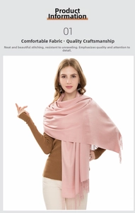 Detail of light pink fringed scarf showing soft texture and tassel ends on a model