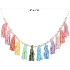 Detail view of 150cm bohemian wood bead garland with colorful cotton tassels in pastel tones