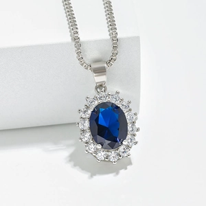 Silver sunflower pendant necklace with oval blue sapphire and white zircon halo crystals