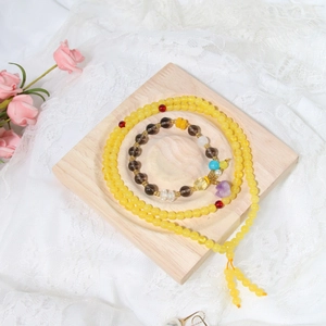 Macro view of crystal beaded bracelets on an elegant solid wooden display jewelry tray