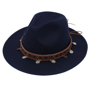 Detailed macro view of the ethnic silver charms and woven band on this navy wool felt hat