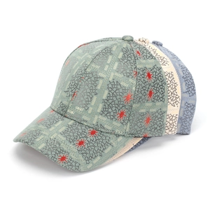 Detailed view of stacked baseball caps with unique moss green crackle texture and red stars