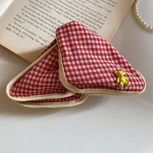 Close-up of red gingham triangular hair claw clip with a cute yellow bear accent detail