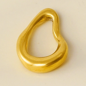 Macro shot of an irregular gold-finished teardrop pendant in polished 304 stainless steel