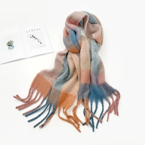 Detailed view of soft mohair texture plaid scarf with colorful fringe on white background