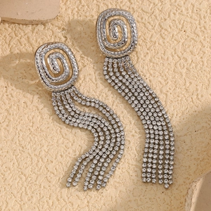 Detail of silver spiral stud earrings with five rows of sparkling rhinestone tassels