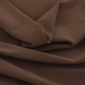 Detail of dark brown dress fabric showing intricate textile texture and soft pleats