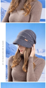 Close-up of dark grey knitted winter hat with silver stripes and SUYLORD leather label
