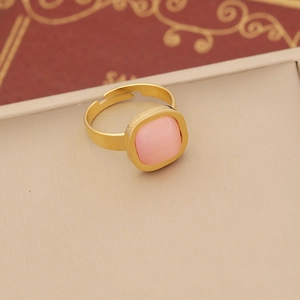 Detail of square pink cat eye stone ring with adjustable gold open band