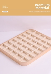 Top-down view of 30-grid jewelry storage tray with champagne metal frame and beige velvet
