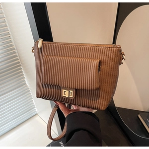 Close-up of brown pleated shoulder bag featuring a square gold metallic twist lock