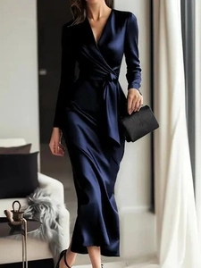Detail of navy blue satin maxi dress with V-neck wrap and waist tie on female model