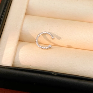 Detailed close-up of a silver twist texture ear cuff with round bead end caps