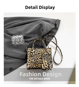Detail view of a leopard print handbag with matching shoulder strap and small coin purse