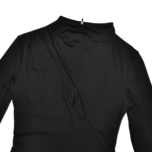 Detailed macro view of the diagonal cutout design and zipper on this black turtleneck dress