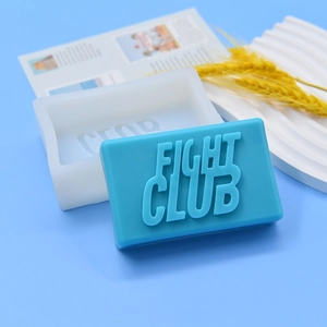 Rectangular Fight Club silicone mold with blue embossed soap on light blue background