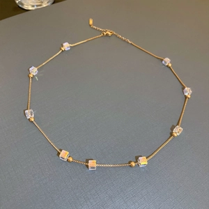 Elegant gold titanium necklace with rainbow crystal cubes and adjustable chain length