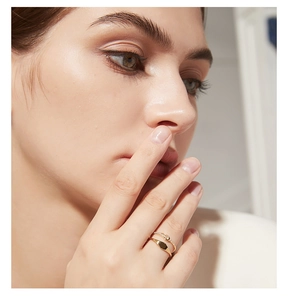 Close-up of gold double-layered ring set with minimalist band and crystal accents