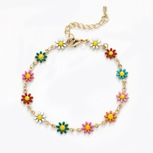 Detail of gold chain bracelet with colorful daisy charms, lobster clasp and extension chain