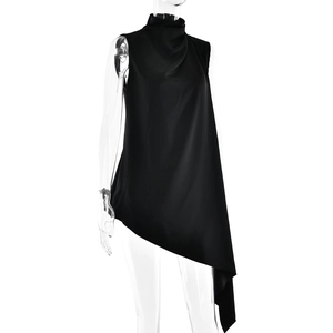 Detail of black mock neck sleeveless top featuring asymmetric hem and silky sheen finish