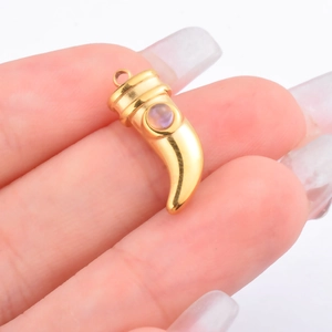 Gold horn pendant with natural round purple stone inlay on white background