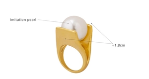 Detail shot of a Y-shaped gold ring with large imitation pearl and 1.8cm width mark
