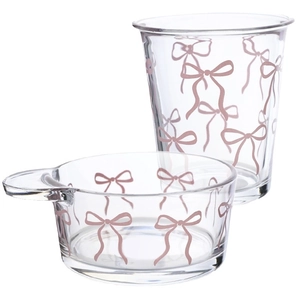 Pink bow pattern clear glass cup and handled salad bowl set on white background