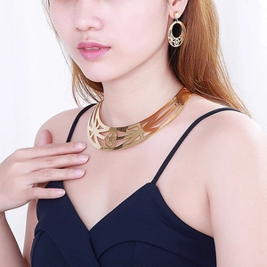 Golden hollow metal collar necklace and earrings set with star patterns on a model