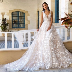 Elegant ivory V-neck sleeveless bridal gown with floral lace embroidery and long train