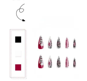 Detailed view of Gothic press-on nails with silver crosses, rhinestones and red gradient