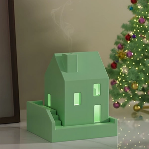 Detail of mint green house-shaped aroma diffuser mold with realistic smoke effect