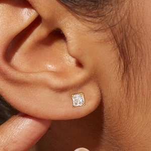 Elegant 18K gold-plated square zircon stud earring displayed on ear in macro view