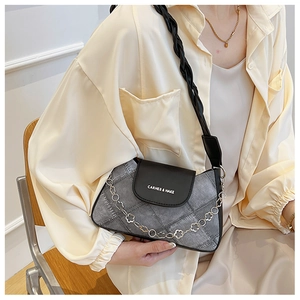 Detail of grey denim texture PU bag with a decorative floral metal chain strap