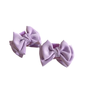 Set of two light purple satin bow hair claws for elegant women's side hair styling